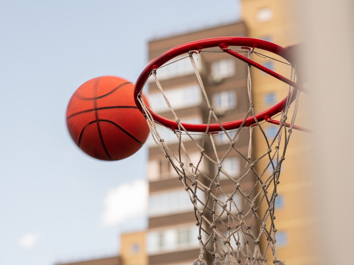 Ball for playing basketball thrown by player close to basket